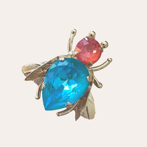 Vlieg broche met oranje en turquoise Swarovski-kristallen