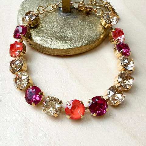 Gold bracelet with pink/orange Swarovski crystals